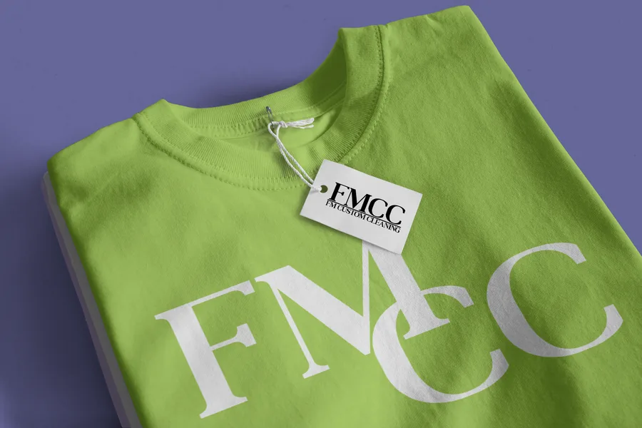 Lime green t-shirt with the FMCC monogram in white and a matching hang tag