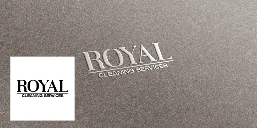 Royal Cleaning Services logo shown as a business card and a large wall sign on a grey textured wall