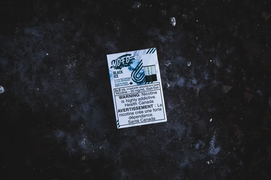 A white Mofo Black Ice pod pack lying flat on dark speckled stone