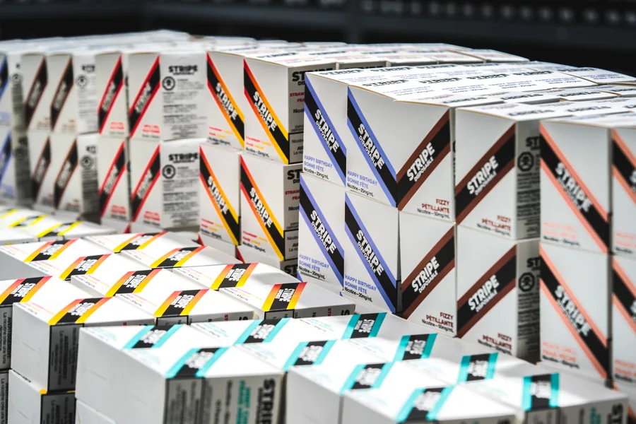 Hundreds of white Stripe cartons in every flavour colour stacked in rows